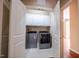 Convenient laundry room with white cabinets, tile floor and modern appliances at 804 Long Meadows Rd, Chapel Hill, NC 27516