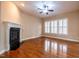 Living room featuring hardwood floors, fireplace, and window with white shutters at 804 Long Meadows Rd, Chapel Hill, NC 27516