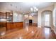 Open floor plan with kitchen island, stainless appliances, and view of the living room and dining area at 804 Long Meadows Rd, Chapel Hill, NC 27516