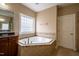 Bright bathroom featuring a soaking tub, vanity, and tile floors at 804 Long Meadows Rd, Chapel Hill, NC 27516