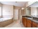 Bright bathroom featuring a soaking tub, glass shower, and granite counters at 804 Long Meadows Rd, Chapel Hill, NC 27516