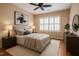 Beautiful bedroom showcases a plush bed, modern art and lots of neutral tones at 804 Long Meadows Rd, Chapel Hill, NC 27516