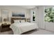 Bedroom featuring large windows, a bed with white bedding, and wood night stands at 81 St Andrews Dr, Zebulon, NC 27597