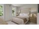 Bedroom with a bed, white bedding, and windows with views of the outdoors at 81 St Andrews Dr, Zebulon, NC 27597