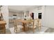 Open-concept dining area featuring a light wood table set with seating for six and views into the kitchen at 81 St Andrews Dr, Zebulon, NC 27597