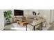 Well lit living room with a sofa, two side chairs, a plant and a tv at 81 St Andrews Dr, Zebulon, NC 27597