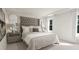 A bright bedroom with a large bed, bedside tables and art at 81 St Andrews Dr, Zebulon, NC 27597