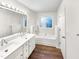 A bathroom with double vanity and soaking tub, with wood flooring at 8425 Fawncrest Dr, Raleigh, NC 27603