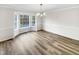 Dining room with hardwood floors and large windows providing ample natural light at 8425 Fawncrest Dr, Raleigh, NC 27603