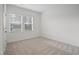 Bright bedroom featuring neutral carpet and ample natural light through a large window at 88 Molly Mac Ln, Angier, NC 27501