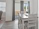 Bright dining area featuring wood-style flooring, modern decor, and backyard views at 88 Molly Mac Ln, Angier, NC 27501