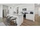 Bright kitchen with stainless steel appliances, granite countertops, and seating at the center island at 88 Molly Mac Ln, Angier, NC 27501
