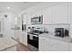 Modern kitchen with stainless steel appliances, white cabinetry and granite countertops at 88 Molly Mac Ln, Angier, NC 27501