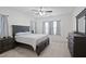 Serene main bedroom featuring neutral carpet, a ceiling fan and ample natural light at 88 Molly Mac Ln, Angier, NC 27501