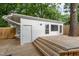 Backyard featuring a wooden deck and separate outbuilding with natural light at 905 N Hyde Park Ave, Durham, NC 27701