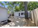 Backyard view featuring a wooden deck, mature trees, and an accessory building at 905 N Hyde Park Ave, Durham, NC 27701