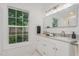 Bright bathroom with double sinks, marble countertops, and a large window providing natural light at 905 N Hyde Park Ave, Durham, NC 27701