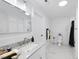 Bright bathroom with a white marble countertop, patterned tile flooring, and white subway tile walls at 905 N Hyde Park Ave, Durham, NC 27701
