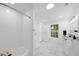 Spacious bathroom featuring a tub, white tile walls and marble tile floors at 905 N Hyde Park Ave, Durham, NC 27701