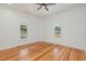 Well-lit bedroom with hardwood floors and two windows, showcasing a bright, inviting space at 905 N Hyde Park Ave, Durham, NC 27701