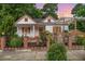 Charming front exterior of a two-story home with a landscaped yard, black fence, and a welcoming porch at 905 N Hyde Park Ave, Durham, NC 27701