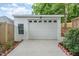 Detached garage with a classic white door and charming decorative windows, adding curb appeal at 905 N Hyde Park Ave, Durham, NC 27701