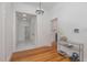 Hallway with hardwood floors leading to the bathroom and living room with a fireplace at 905 N Hyde Park Ave, Durham, NC 27701