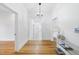 Inviting hallway featuring hardwood floors, white walls, and decorative lighting at 905 N Hyde Park Ave, Durham, NC 27701