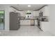 Well-lit kitchen featuring white cabinets, stainless appliances, dark countertops, and a stylish tile floor at 905 N Hyde Park Ave, Durham, NC 27701