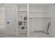 Functional laundry area featuring built-in shelving, and white tile floors for organization and convenience at 905 N Hyde Park Ave, Durham, NC 27701