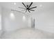 Bright and airy living room with white marble floors, white walls and a modern ceiling fan at 905 N Hyde Park Ave, Durham, NC 27701
