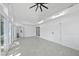 Bright living room featuring tile flooring, modern ceiling fan, and access to a bathroom and sliding glass door at 905 N Hyde Park Ave, Durham, NC 27701