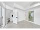 Bright living room featuring tile flooring, modern ceiling fan, and access to a bathroom and sliding glass door at 905 N Hyde Park Ave, Durham, NC 27701