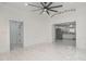 Bright and airy living room featuring white marble floors, white walls, and an adjacent kitchen at 905 N Hyde Park Ave, Durham, NC 27701
