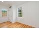 Bright room with hardwood floors and two windows, showcasing a comfortable and well-lit space at 905 N Hyde Park Ave, Durham, NC 27701