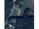 Aerial view of property at 9115 NC-157 with surrounding trees and roads at 9115 Nc 157, Rougemont, NC 27572
