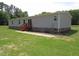 Back of home featuring a mix of brick foundation and vinyl siding, with steps leading up to a patio at 9115 Nc 157, Rougemont, NC 27572