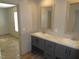 A bright bathroom features a double vanity with marble countertop, wood-look floors and neutral colors at 9115 Nc 157, Rougemont, NC 27572