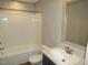 A clean bathroom with a white tub and shower, a large vanity, and a toilet, is designed for comfort at 9115 Nc 157, Rougemont, NC 27572