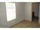 This bedroom has a large window that lets in plenty of natural light and wood-look laminate flooring at 9115 Nc 157, Rougemont, NC 27572