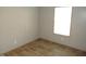 Small bedroom with neutral walls, wood-look flooring, and natural light from the window at 9115 Nc 157, Rougemont, NC 27572