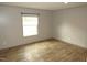 This bedroom offers wood-look floors and a window to let in natural light at 9115 Nc 157, Rougemont, NC 27572