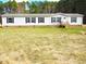 Inviting home with neutral siding, black shutters, complemented by the natural beauty of the surrounding landscape at 9115 Nc 157, Rougemont, NC 27572
