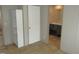 View of a hallway with a shelf in the corner and a doorway into a bright bathroom at 9115 Nc 157, Rougemont, NC 27572