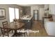 Modern kitchen with a gray island, stainless steel appliances, and an adjacent dining area at 9115 Nc 157, Rougemont, NC 27572