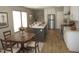 Bright kitchen featuring an island with a sink, stainless steel refrigerator, and dining area at 9115 Nc 157, Rougemont, NC 27572