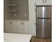 Kitchen featuring stainless steel refrigerator, white cabinets, gray backsplash, and modern finishes at 9115 Nc 157, Rougemont, NC 27572