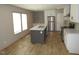 Modern kitchen with stainless steel appliances, a kitchen island, and bright natural light at 9115 Nc 157, Rougemont, NC 27572