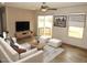 Comfortable living room featuring hardwood floors, sliding glass door, tv, and natural light at 9115 Nc 157, Rougemont, NC 27572