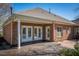 A brick home featuring a covered deck and patio offer an ideal indoor-outdoor living space at 9413 Lake Villa Way, Raleigh, NC 27614